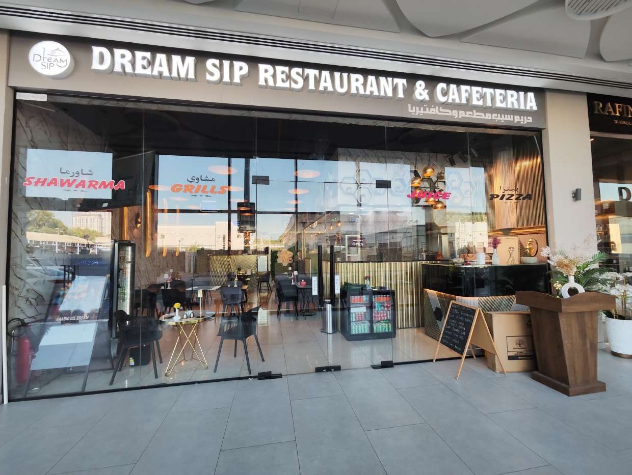 Dream Sip restaurant exterior at night
